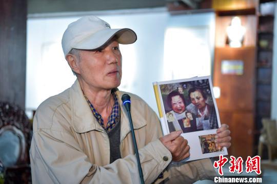 在瓊旅美畫家易志群對羅門為其在臺北畫展寫評論推介心存感激，展示刊登其為羅門蓉子所作肖像的海南《新海岸》雜志。　駱雲飛 攝