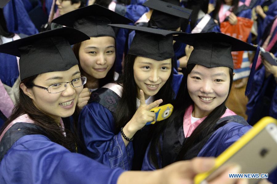 As annual college graduation season comes, graduates are busy with having photos taken on campus as a memento.