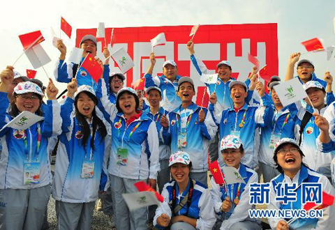 10月1日,世博會城市服務站點志願者代表在活動現場歡呼。